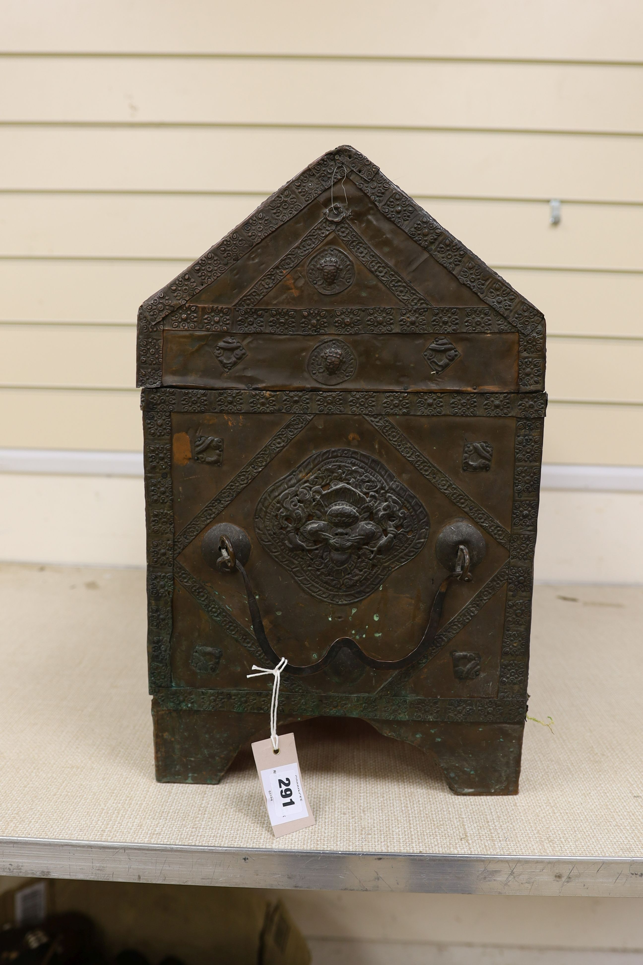 A Tibetan copper repousse-work casket, 20th century, 65cm wide, 49.5cm